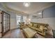 A cozy living room with hardwood floors and a decorative mirror and window at 5825 Trailwood Ct, Suwanee, GA 30024