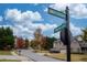 Street corner view showcasing well-maintained homes with mature trees at 5825 Trailwood Ct, Suwanee, GA 30024