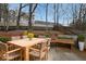 Outdoor patio with dining table and chairs surrounded by lush greenery and a wooden fence at 5989 Zane Ct, Douglasville, GA 30135