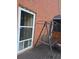 Exterior brick wall with covered porch with swing and seating at 2151 Overland Way, Powder Springs, GA 30127