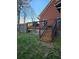 Backyard with a well-maintained wooden deck, stairs and a lush green lawn at 2151 Overland Way, Powder Springs, GA 30127