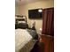 This bedroom has a large TV, curtains, and a mirrored dresser at 2151 Overland Way, Powder Springs, GA 30127