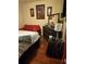 Inviting bedroom showcasing a dark dresser and a comfortable red love seat at 2151 Overland Way, Powder Springs, GA 30127