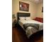 Cozy bedroom featuring a comfortable queen-size bed and a decorative wall painting at 2151 Overland Way, Powder Springs, GA 30127