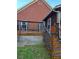 Backyard brick house with a wood deck, stairs and a lush green lawn at 2151 Overland Way, Powder Springs, GA 30127