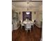 Formal dining room featuring elegant chandelier and hardwood flooring at 2151 Overland Way, Powder Springs, GA 30127