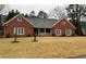 Charming single-story brick home with a cozy front porch and well-maintained lawn at 2151 Overland Way, Powder Springs, GA 30127
