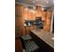 Cozy kitchen featuring an island, granite countertops, and plenty of wooden cabinet space at 2151 Overland Way, Powder Springs, GA 30127