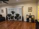 Well-lit living room boasts hardwood floors, large windows, and stylish decor at 2151 Overland Way, Powder Springs, GA 30127