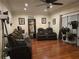 Bright living room featuring hardwood floors, natural light, and comfortable couches at 2151 Overland Way, Powder Springs, GA 30127