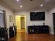 Well-lit living room features hardwood floors and a wall mounted TV at 2151 Overland Way, Powder Springs, GA 30127