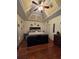 Comfortable main bedroom with tray ceiling and hardwood flooring at 2151 Overland Way, Powder Springs, GA 30127