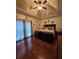 Comfortable main bedroom with tray ceiling and hardwood flooring at 2151 Overland Way, Powder Springs, GA 30127