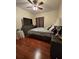 Inviting bedroom with dark wood floors, ceiling fan and dresser at 2151 Overland Way, Powder Springs, GA 30127