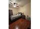 Well-lit bedroom with dark wood floors, ceiling fan and neutral-toned decor at 2151 Overland Way, Powder Springs, GA 30127