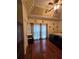 Comfortable main bedroom with tray ceiling and hardwood flooring at 2151 Overland Way, Powder Springs, GA 30127