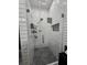 Modern tiled shower with glass door, niche and updated fixtures at 2151 Overland Way, Powder Springs, GA 30127