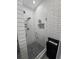 Modern tiled shower with glass door, niche and updated fixtures at 2151 Overland Way, Powder Springs, GA 30127