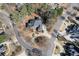 A high-angle view of a distinguished home surrounded by lush trees and a meticulously landscaped circular driveway at 2821 Grey Moss Pass, Duluth, GA 30097