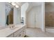 Secondary bathroom with white vanity, tile floor, large mirror and a shower-tub combination at 2821 Grey Moss Pass, Duluth, GA 30097