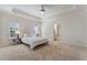 Minimalist bedroom features a tray ceiling, carpet, plantation shutters, and modern lighting at 2821 Grey Moss Pass, Duluth, GA 30097