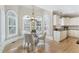 Charming breakfast nook with large windows, a chandelier, and views of the lush landscaping, and nearby kitchen at 2821 Grey Moss Pass, Duluth, GA 30097