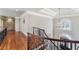 Beautiful upstairs hallway features hardwood floors, decorative railing and chandelier over entry at 2821 Grey Moss Pass, Duluth, GA 30097