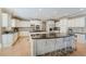 Gourmet kitchen with double islands, stainless steel appliances, custom cabinetry, and dark granite countertops at 2821 Grey Moss Pass, Duluth, GA 30097