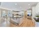 Bright, open kitchen with stainless steel appliances, a large island, and a breakfast nook with ample natural light at 2821 Grey Moss Pass, Duluth, GA 30097