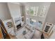 Bright, airy living room with a fireplace, built-in shelves, and soaring two-story windows at 2821 Grey Moss Pass, Duluth, GA 30097