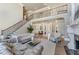 Grand living room showcasing a cozy fireplace, built-in shelves, and a view of the dining area at 2821 Grey Moss Pass, Duluth, GA 30097