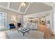 Spacious living room with a fireplace, leading to an open-concept kitchen featuring stainless steel appliances at 2821 Grey Moss Pass, Duluth, GA 30097
