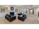 Elegant living room with a cozy fireplace and neutral-toned carpet and black sofas at 2821 Grey Moss Pass, Duluth, GA 30097