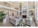 Open-concept living room with a fireplace, built-in shelves, and an upper-level balcony at 2821 Grey Moss Pass, Duluth, GA 30097