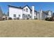 Spacious backyard featuring well-maintained lawn and a glimpse of neighboring houses at 2882 Manor Glen Ln, Suwanee, GA 30024