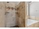 Luxurious bathroom featuring a stand up shower with rock accents and garden tub at 2882 Manor Glen Ln, Suwanee, GA 30024