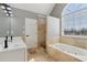Bright bathroom featuring a soaking tub, walk-in shower, and double sink vanity at 2882 Manor Glen Ln, Suwanee, GA 30024