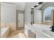 Bathroom with double sink vanity and walk-in shower and large mirror at 2882 Manor Glen Ln, Suwanee, GA 30024