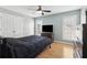 Bright bedroom features neutral walls, natural light, ceiling fan, and wood-look flooring at 2882 Manor Glen Ln, Suwanee, GA 30024
