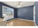 Bedroom featuring large windows with wood floor and ceiling fan at 2882 Manor Glen Ln, Suwanee, GA 30024