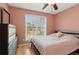 Bedroom features wood floors, natural light and a ceiling fan at 2882 Manor Glen Ln, Suwanee, GA 30024