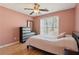 Bedroom features wood floors, natural light, dresser and ceiling fan at 2882 Manor Glen Ln, Suwanee, GA 30024