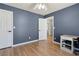 Bedroom featuring a ceiling fan, light wood floors and access to en-suite bath at 2882 Manor Glen Ln, Suwanee, GA 30024