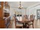 Formal dining room showcasing a wooden table set with chairs and a hutch, illuminated by a chandelier at 2882 Manor Glen Ln, Suwanee, GA 30024