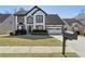 Charming two-story home featuring black and white trim, a well-manicured lawn, and an attached two-car garage at 2882 Manor Glen Ln, Suwanee, GA 30024