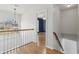 Upstairs hallway with hardwood floors and natural light from the front window at 2882 Manor Glen Ln, Suwanee, GA 30024