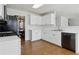 Well-equipped kitchen featuring white cabinets, black appliances, and tile flooring at 2882 Manor Glen Ln, Suwanee, GA 30024