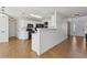 Open-concept kitchen with white cabinets, black appliances, and easy access to other living areas at 2882 Manor Glen Ln, Suwanee, GA 30024