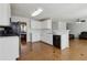 Spacious kitchen featuring white cabinets, black appliances, and tile flooring for easy maintenance at 2882 Manor Glen Ln, Suwanee, GA 30024