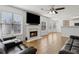 Cozy living room featuring a fireplace, large windows, and comfortable leather seating at 2882 Manor Glen Ln, Suwanee, GA 30024